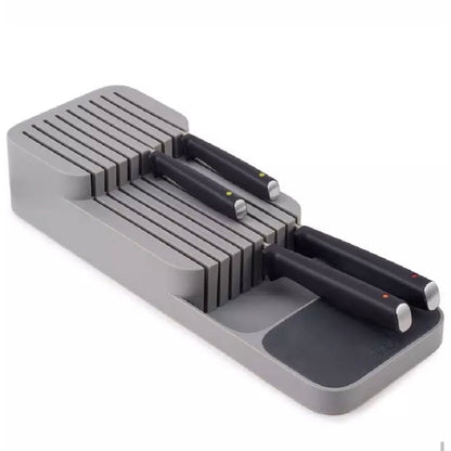 Kompakter und eleganter Messer-Organizer in Grau mit zwei Ebenen für Messer unterschiedlicher Größen, bestückt mit Messern mit schwarzen Griffen und farbigen Markierungen. Der Organizer bietet eine sichere und ordentliche Aufbewahrungslösung und ist ideal für eine übersichtliche und zugängliche Anordnung in jeder Küchenschublade.